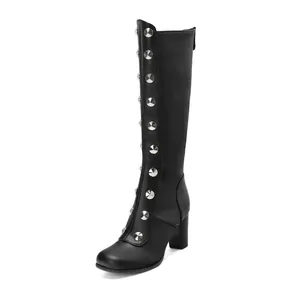 Side view of black knee-high boots featuring silver rivet studs and stylish block heels