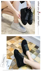 Lifestyle view of women's chunky platform sneakers with full rhinestone embellishment