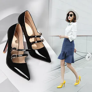 Chic black patent leather stilettos with double straps shown in a lifestyle setting.
