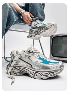 Dynamic low-angle shot of silver and blue chunky dad sneakers with thick soles