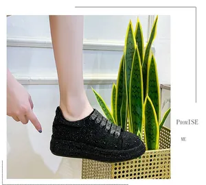 Close-up of black rhinestone platform sneakers for women worn with casual styling
