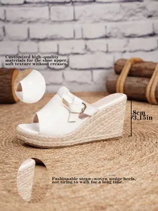 Detail view of white crocodile texture wedge sandals with 8cm straw-woven heels