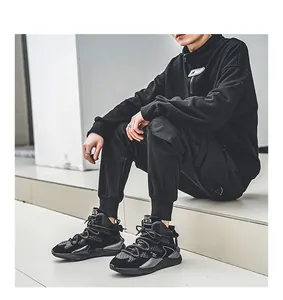 Detailed macro view of black faux leather chunky sneakers worn by a model in urban setting