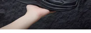 Detailed view of black water-resistant leather texture on men's safety shoes