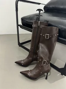 French vintage dark brown knee-high boots with silver studs and buckles detail.