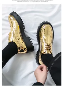 Nahaufnahme von glänzenden goldenen Plateau-Oxfordschuhen mit Brogue-Details