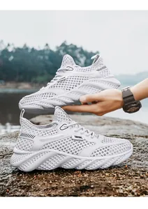 Breathable white large-mesh sneakers for men with thick textured soles in outdoor setting