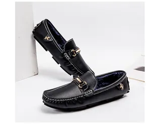 Detail view of black mens winter loafers with warm fur lining and gold buckles
