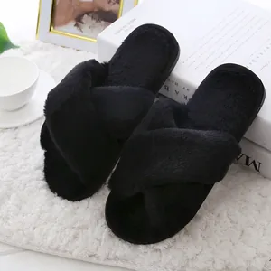 Elegant black criss-cross fuzzy slippers for indoor home wear with soft plush texture.