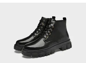Detailed side view of black genuine leather Martin boots with thick rubber soles