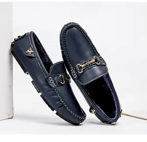 Detailed view of navy blue men's fleece-lined loafers with elegant gold metal buckle