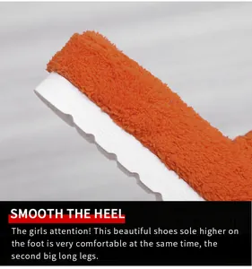 Detail view of fuzzy orange toweling slippers featuring thick scalloped white soles