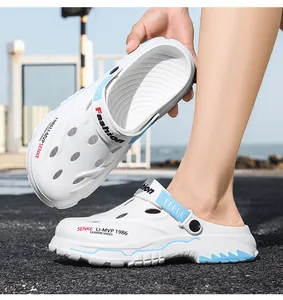 Detail view of white men's breathable clogs with blue accents for summer outdoor beach use.