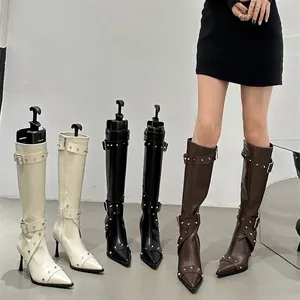 Vintage knee-high boots with studded buckle straps and elegant pointed toe heels