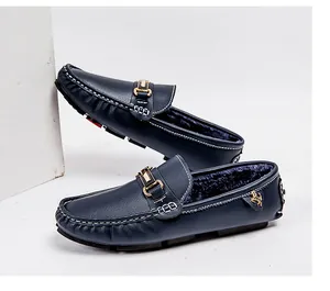 Detail view of navy blue men's fur-lined loafers with gold buckle