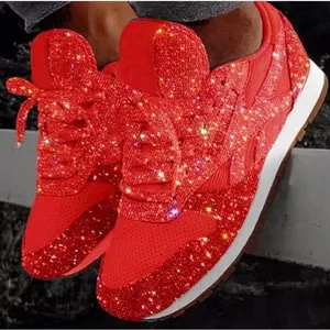 Detail view of sparkling red rhinestone platform sneakers for women with sequins.