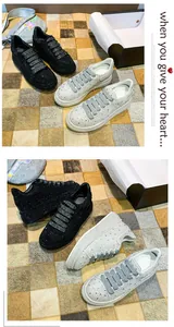 Close-up detail of rhinestone-embellished chunky platform sneakers in black and silver finishes