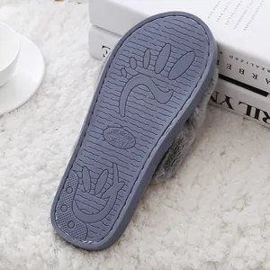 Detailed view of grey plush slipper sole featuring non-slip grip and size marking