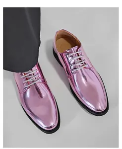 Detailed close-up view of shiny pink metallic dress shoes for men with silver glitter laces.