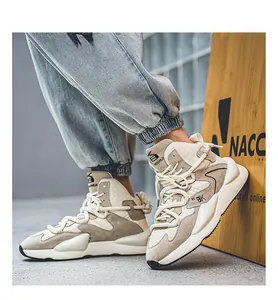 Close-up of men's high-top beige casual sneakers worn with denim jeans.