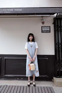 Stylish women's black Mary Jane shoes paired with a casual denim pinafore dress