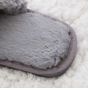 Detail close-up showing the soft grey fuzzy slipper plush texture and stitched sole edge
