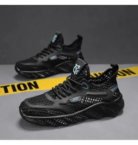 Detailed macro view of men's black breathable hollow mesh fly-knit running sneakers