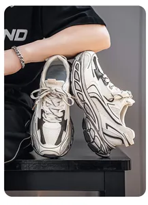 Detailed side view of beige chunky sneakers with thick soles and breathable mesh.