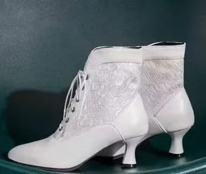 Side view of white Victorian lace-up ankle boots with delicate lace panels and kitten heels