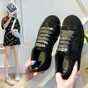 Detailed view of black rhinestone chunky sneakers for women with thick soles.