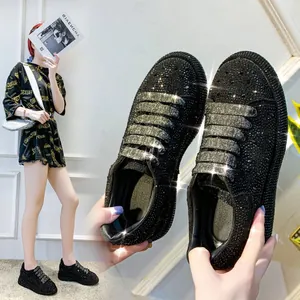 Detailed view of black rhinestone platform sneakers for women with sparkly laces