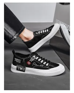 Side view of black men's canvas sneakers with thick white soles and decorative text