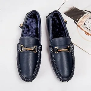 Men's warm fur-lined loafers in navy blue leather with stylish metal bit and white stitching.