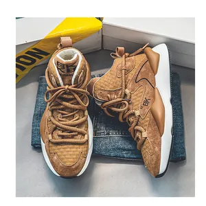 Close-up detail of brown high-top chunky sneakers with rope laces on a denim background