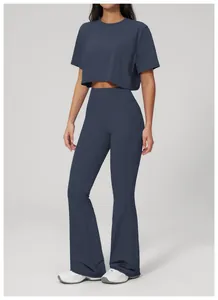 Full body view of navy blue high-waist flare workout pants and matching crop top set