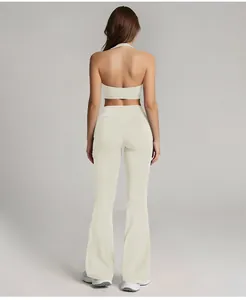 Back view of cream-colored high-waisted flared yoga pants with halter sports crop top