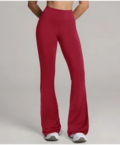 Front view detail of high-waisted burgundy flared yoga pants worn by a fit model