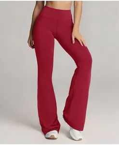 Close-up detail of high-waisted flared sports yoga leggings in a vibrant deep red shade