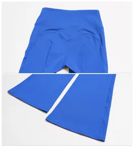 Detailed view of high-waisted booty-lifting seams and flared hems on blue yoga pants