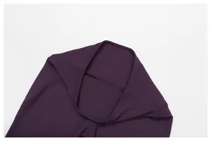 Detailed close-up of the reinforced high-waisted waistband on purple flare yoga pants