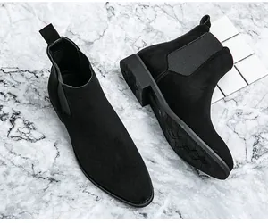 Detailansicht der schwarzen Chelsea-Boots aus Wildleder mit Sohle und spitzer Kappe.
