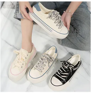 Detailed view of women's platform canvas sneakers in multiple colors with braided laces