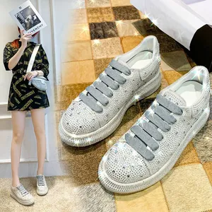 Detail shot of sparkling rhinestone-encrusted silver platform sneakers for women