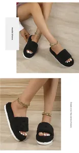 Detail shot of stylish black plush slippers with a comfortable thick white sole
