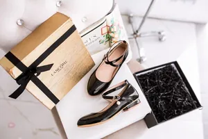 Detailed view of elegant black patent leather Mary Jane shoes for girls with pearl charm