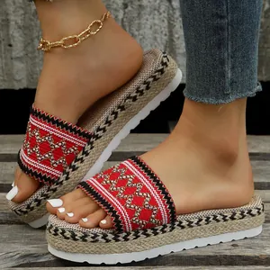 Detailed view of ethnic pattern platform espadrille slides with woven jute rope texture.