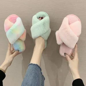 Close-up detail of soft crisscross faux fur slippers in various pastel colors and rainbow