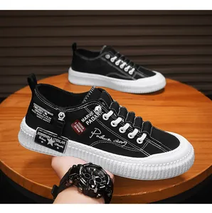 Close-up detail of black canvas platform sneakers for men with trendy text patterns and thick sole