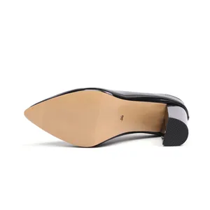 Close-up detail of the anti-slip sole and chunky heel on a black pointed-toe mule