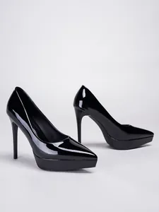 Detailed view of elegant black patent leather pointed toe platform stiletto high heels
